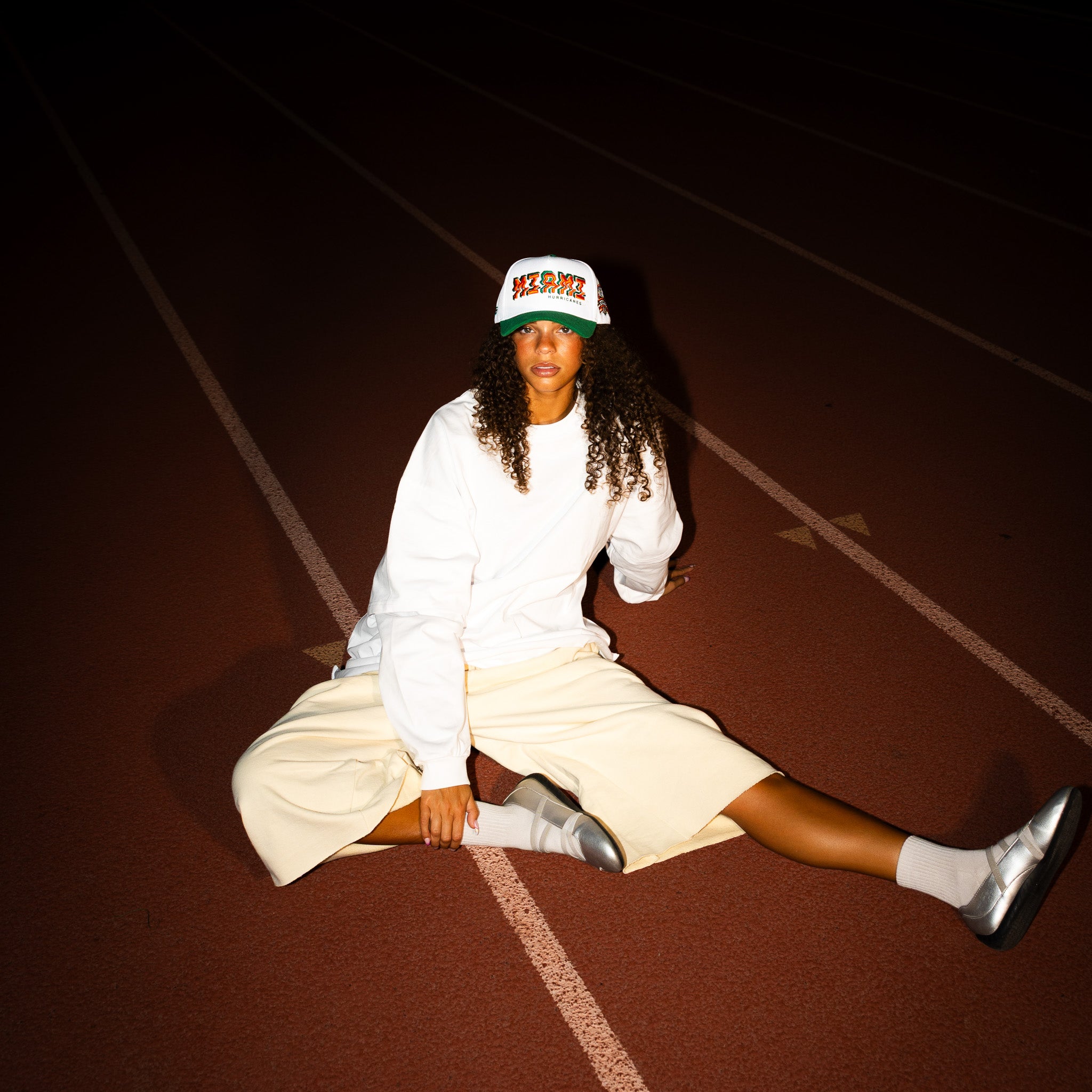 Miami Hurricanes Hat White & Green Corduroy Stadium Pulse Snapback - On Model Seated Portrait Lifestyle