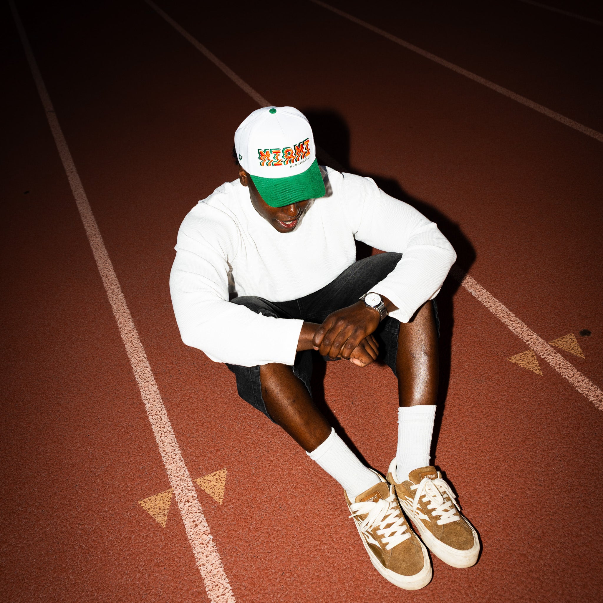 Miami Hurricanes Hat White & Green Corduroy Stadium Pulse Snapback - On Model Seated Lifestyle
