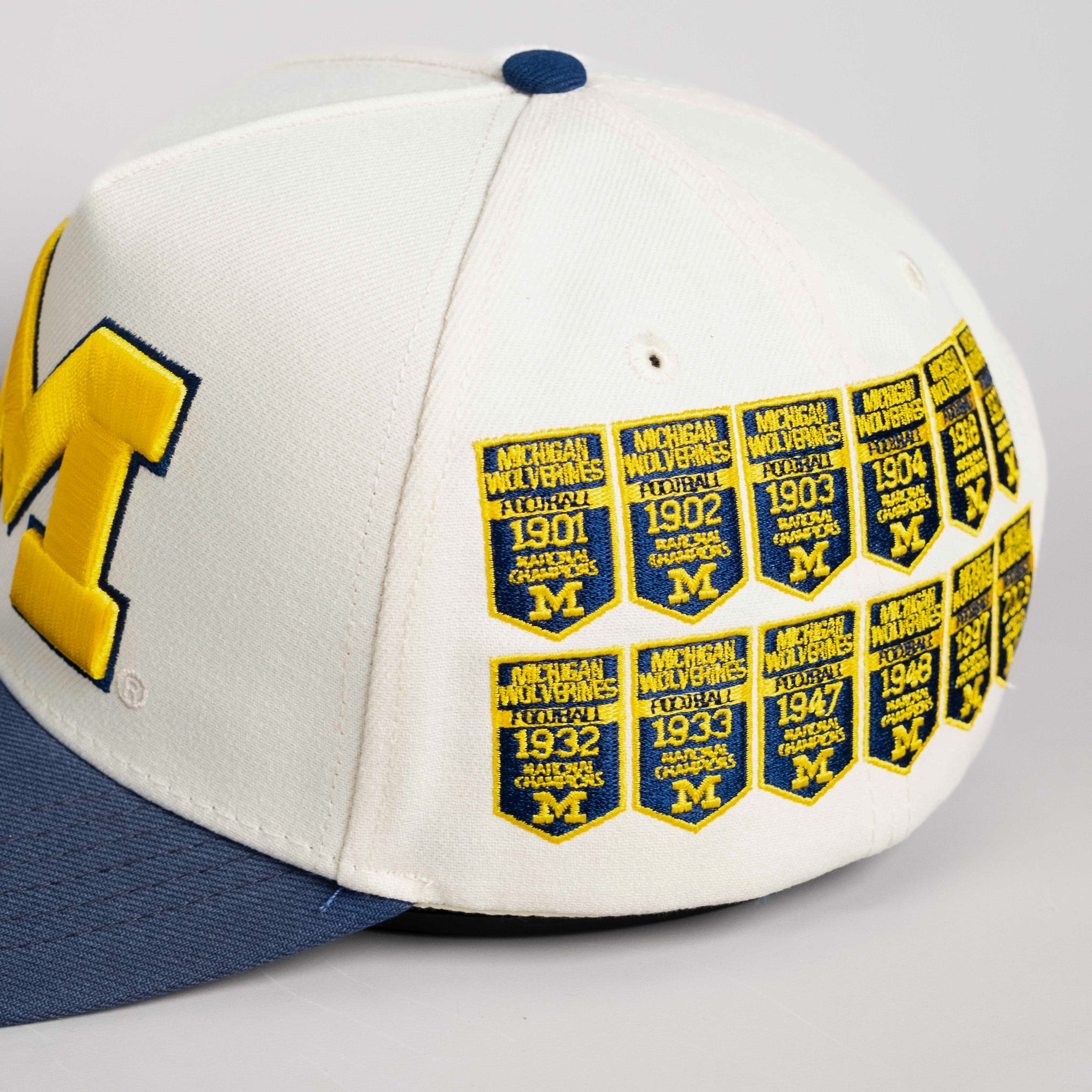 Michigan Wolverines Hat Cream & Navy Banners Snapback - Side Patch Detail