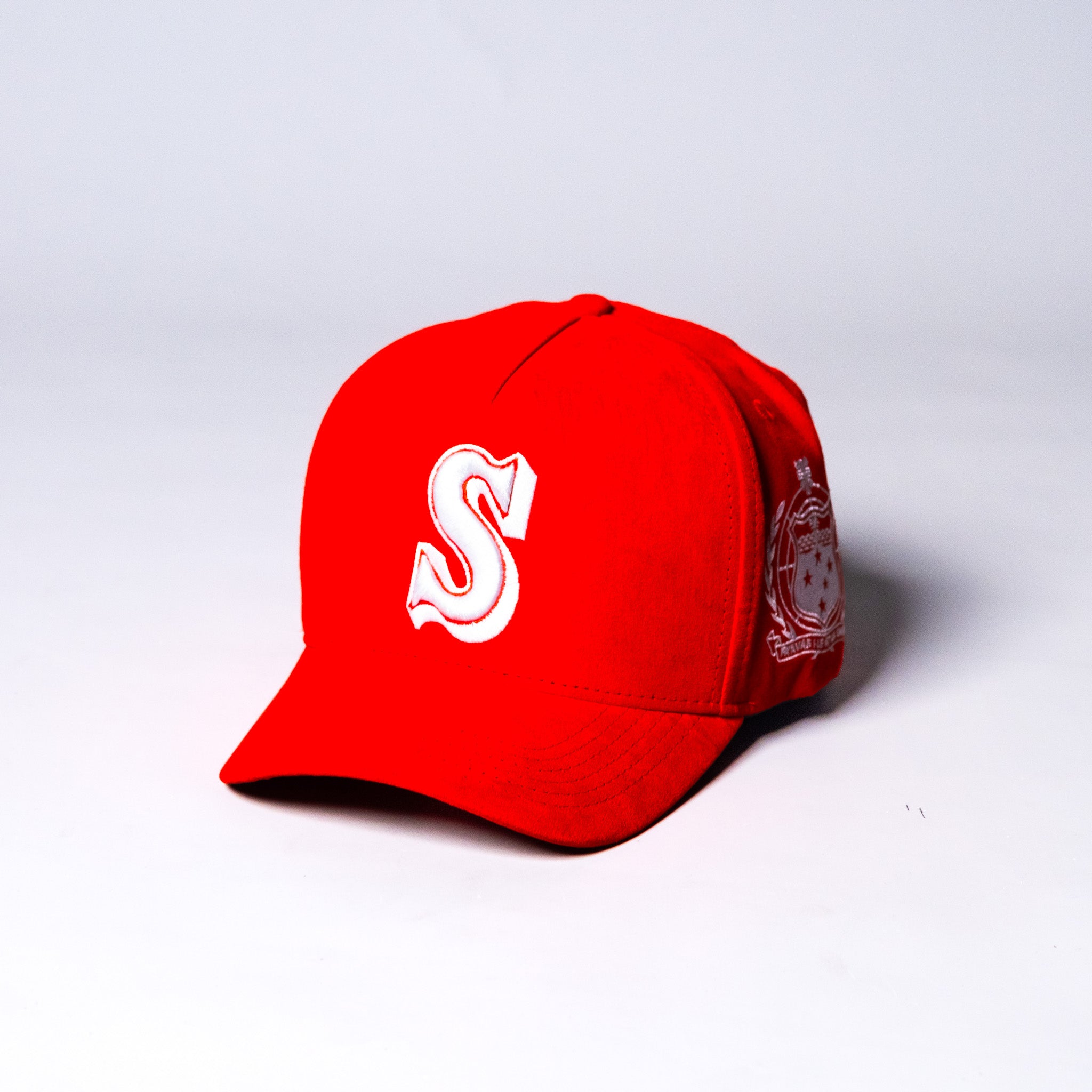 Samoa Red Suede Snapback Hat with White S Logo and Coat of Arms Patch - Angled View