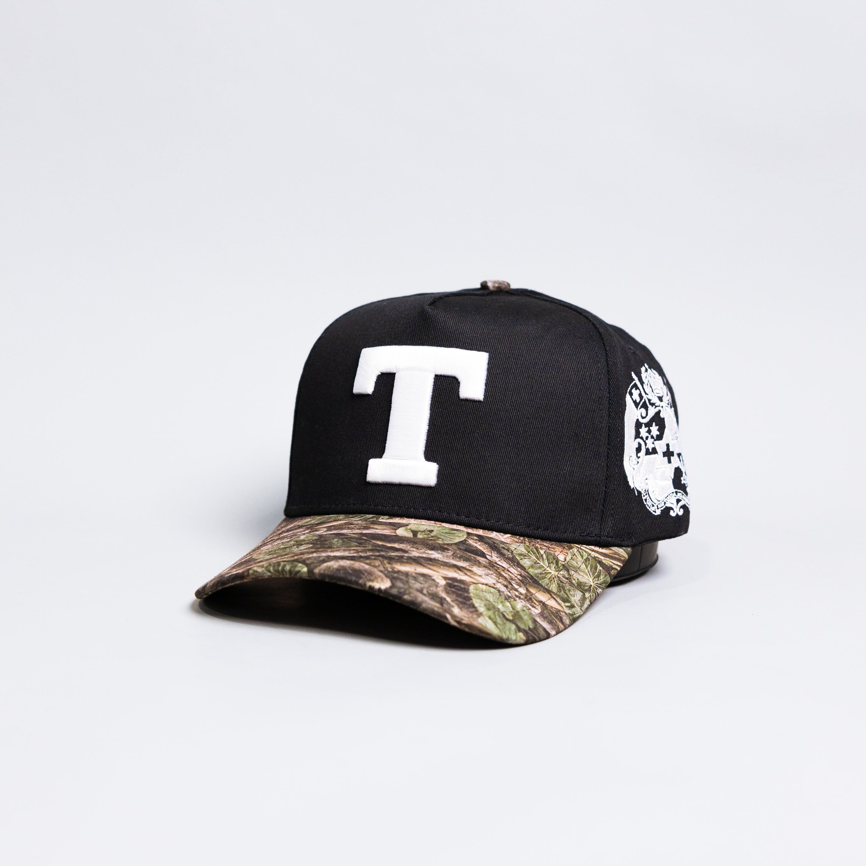 Tonga T Hat Black Polynesian Camo Brim White Logo Coat of Arms Snapback - Angled View