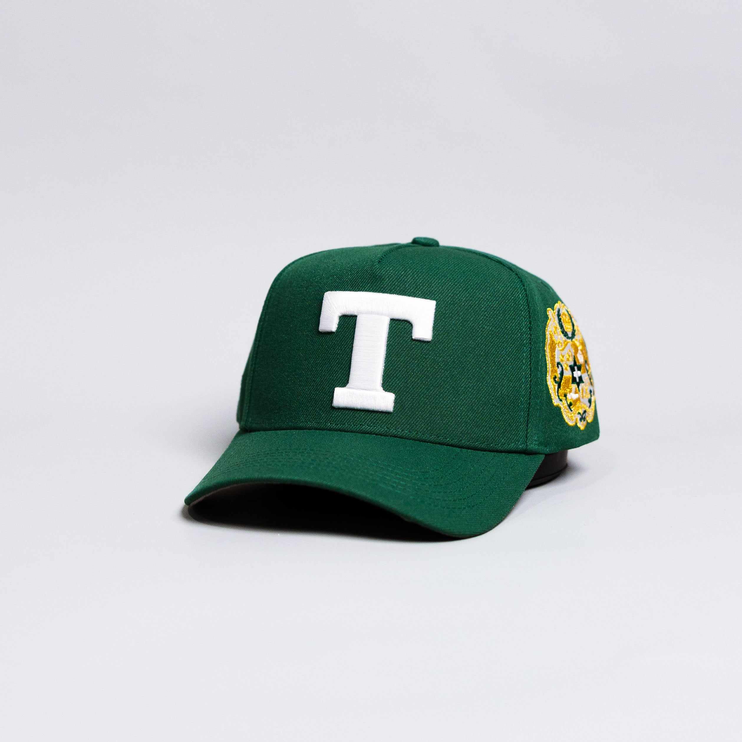 Tonga T Hat Green White Logo Gold Coat of Arms Patch Snapback - Angled View