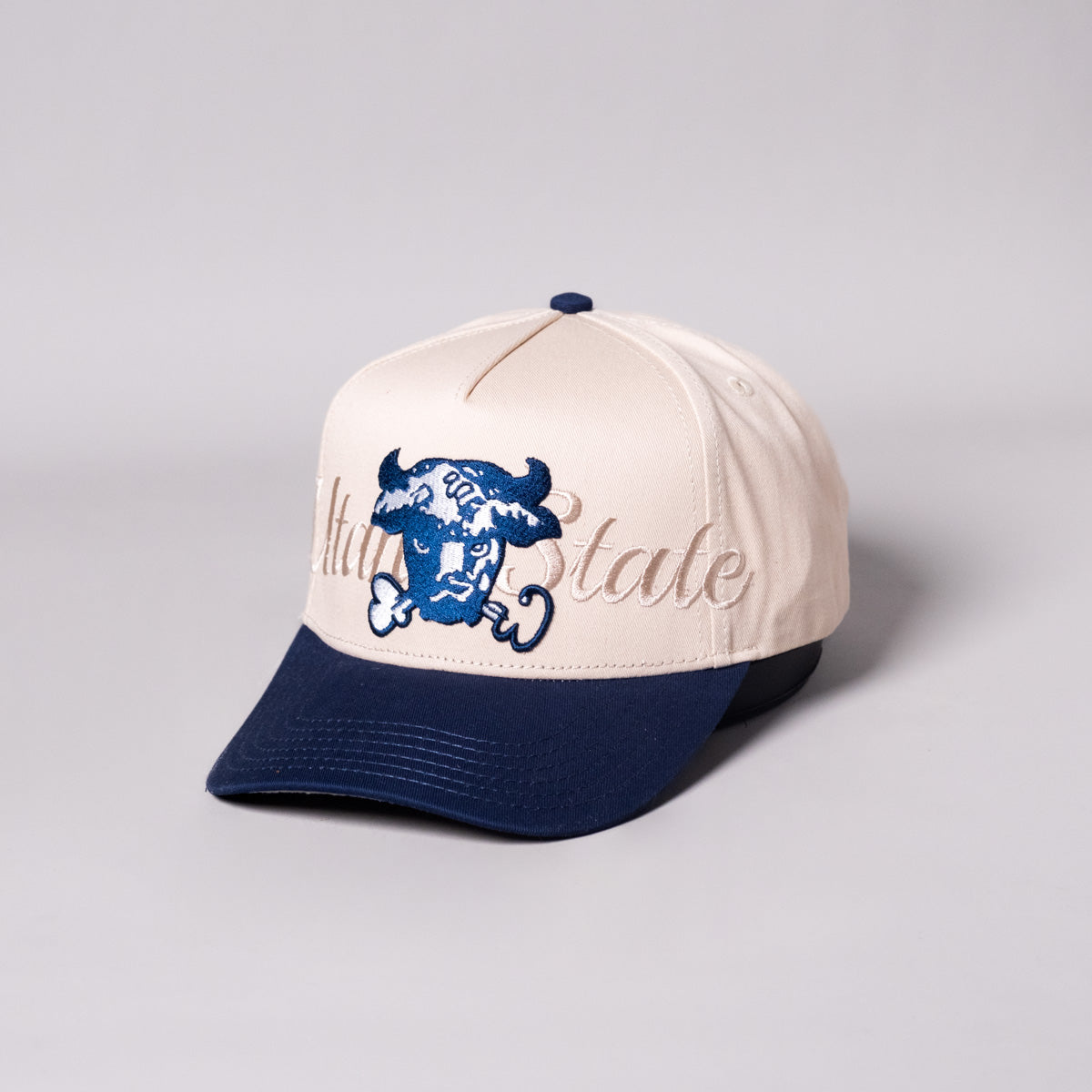 Utah State Aggies Bull Hat Cream & Navy Writtn Snapback - Angled View
