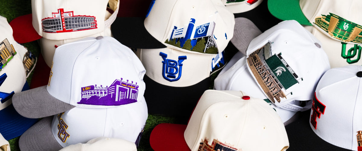 Pile of officially licensed Woodn Grail college hats