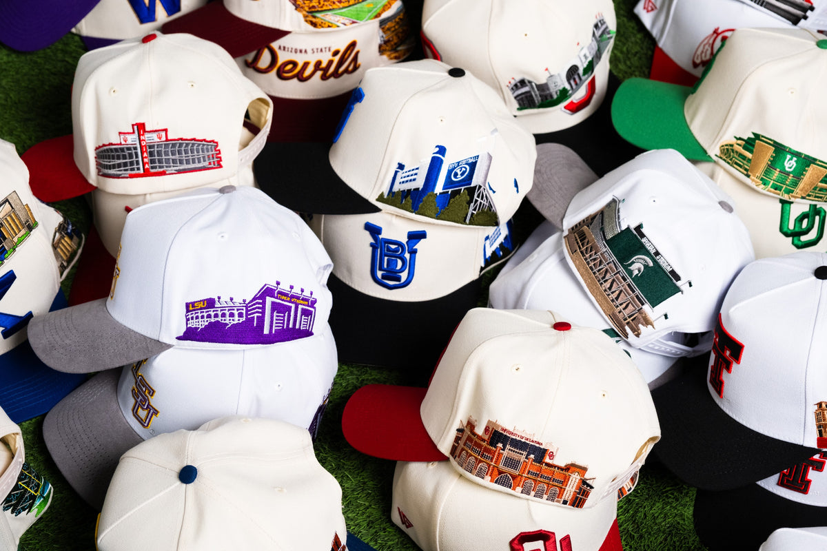 Pile of officially licensed Woodn Grail college hats